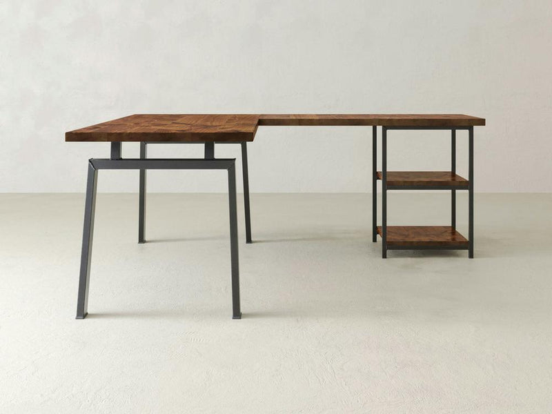 The James & James Fulton Corner Desk combines industrial elegance with a minimalist wooden top and sleek metal frame, featuring two shelves for a chic look. It perfectly complements light grey floors and walls, offering customization options to fit any space.