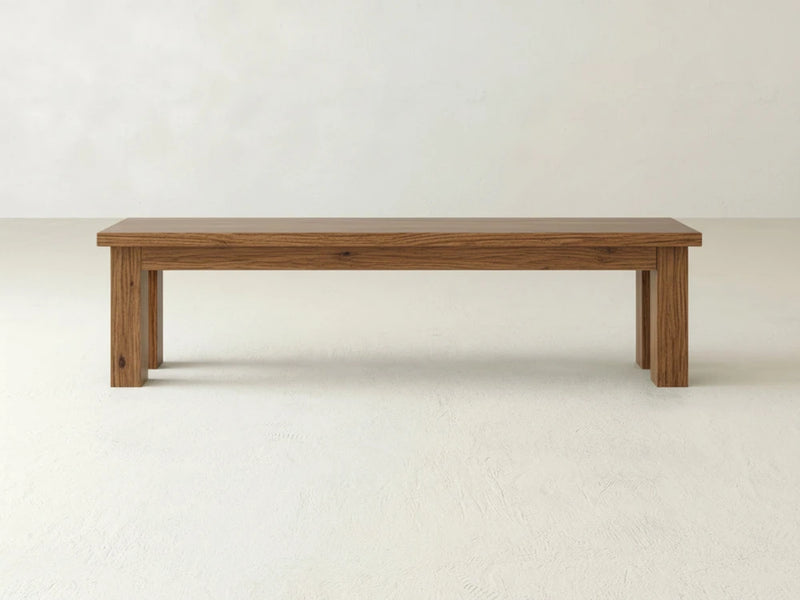 The James+James Farmhouse Bench - Almond on Oak features a rectangular wooden seat and four straight legs, displayed against a plain white background.