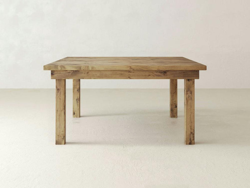 Close-up of the Farmhouse Square Dining Table - Harvest Wheat from James+James showcasing its natural grain and texture. The wood features warm brown tones with a knot and subtle variations in color, highlighting the organic and rustic character of the material.