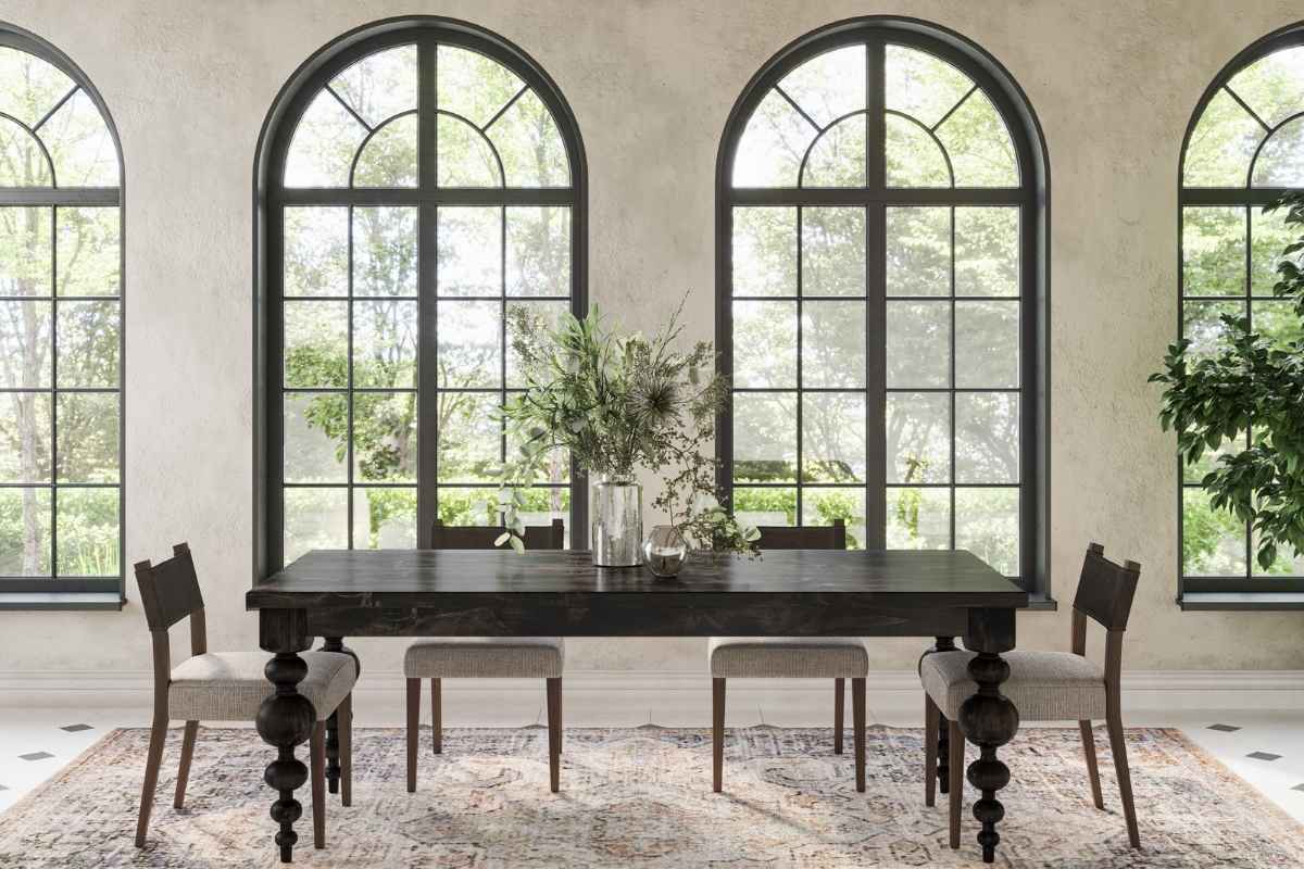 Solid hardwood dining table with turned legs in a bright room, styled with seasonal greenery to highlight proper furniture care.  