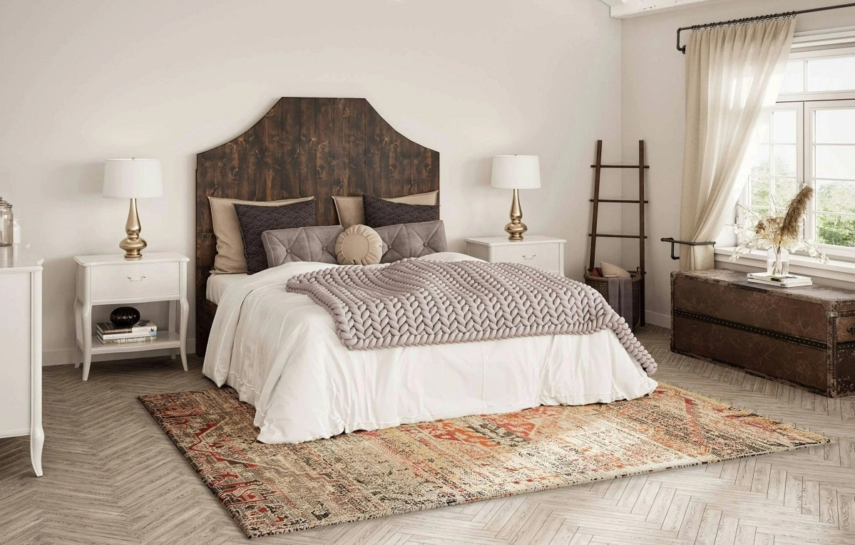 Bedroom with a solid wood panel bed frame and upholstered bedding, illustrating design features to compare with platform beds.  