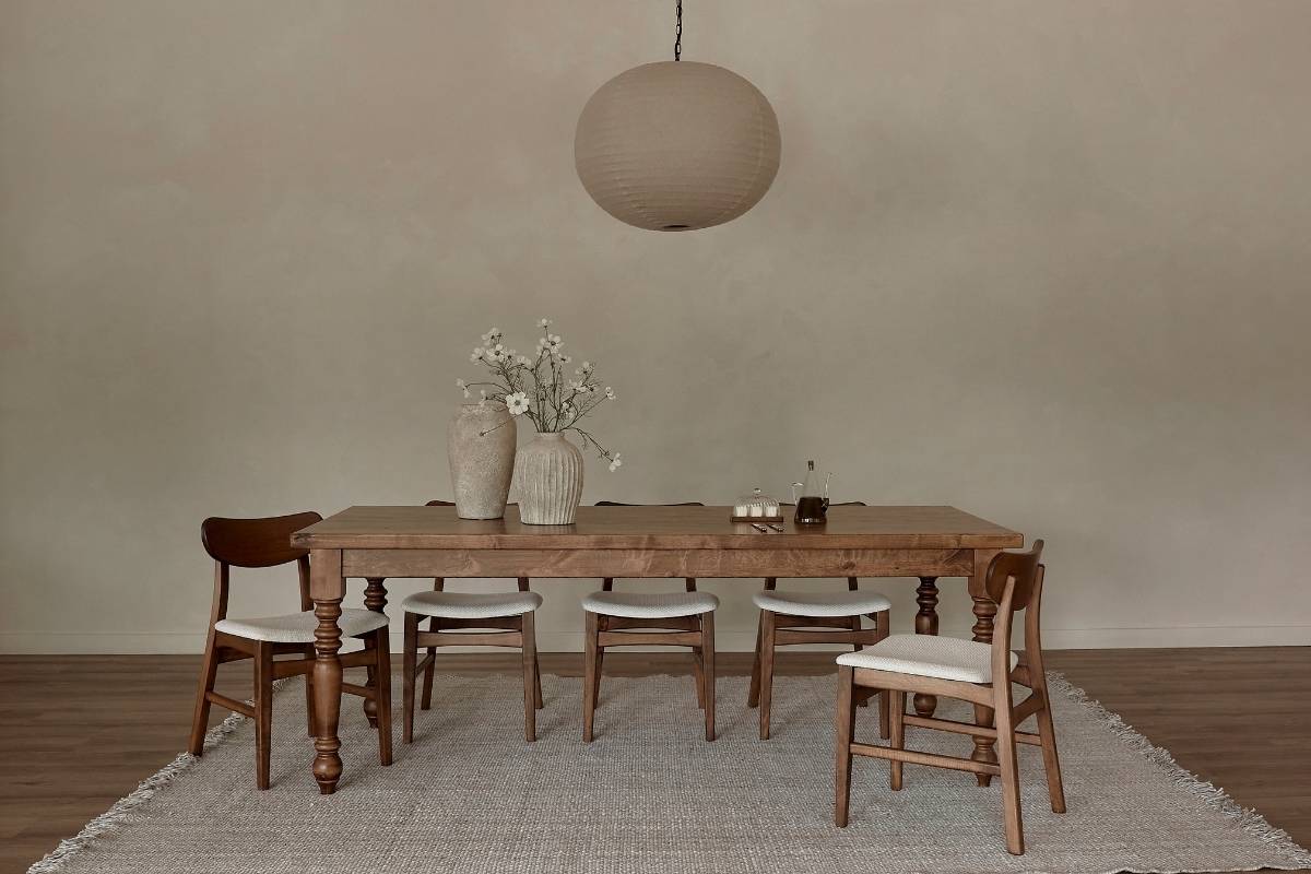 American-made solid wood dining table with classic turned legs and neutral chairs, reflecting quality craftsmanship and sustainable interior design.  