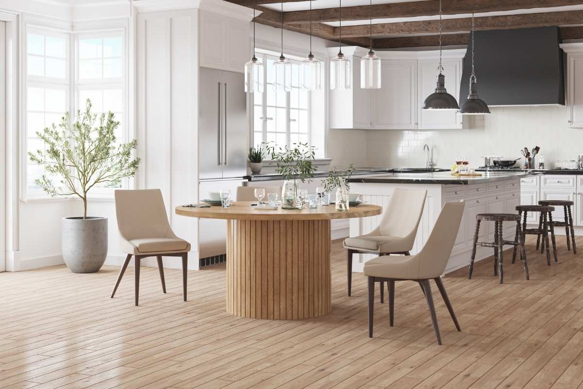 Modern kitchen with a round solid wood dining table and neutral chairs, reflecting timeless interior design that remains in demand for the future.  
