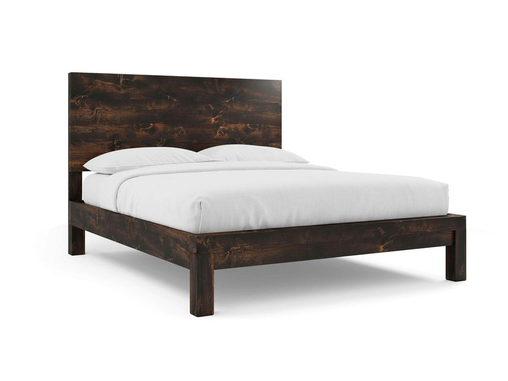 The Sawyer Bed by James+James, crafted in Tobacco on Alder, features a tall wooden headboard and is styled with white bedding and two pillows, set against a plain white background.