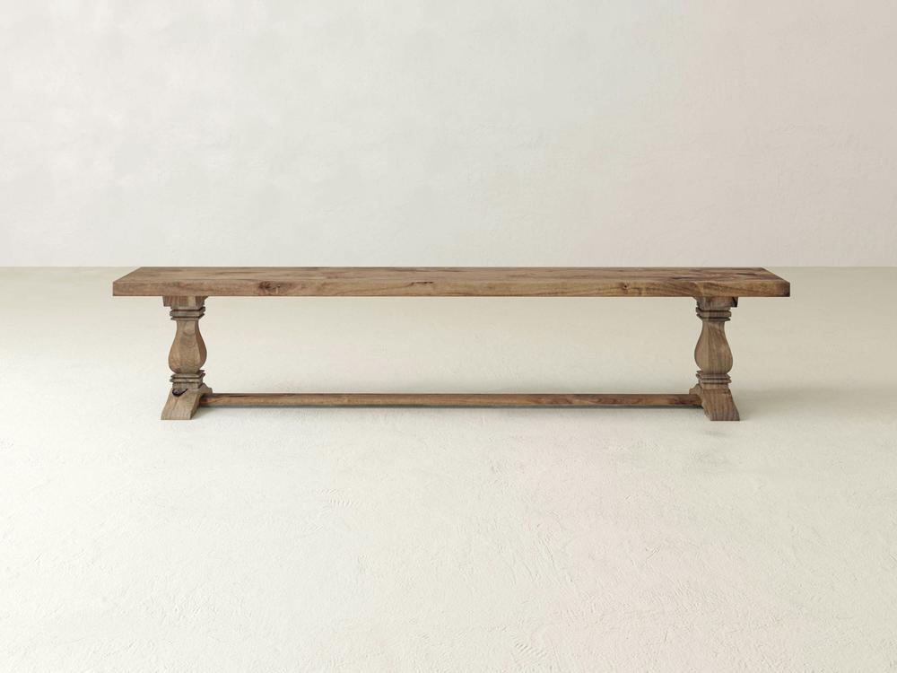 The Heirloom Bench - Harvest Wheat on Alder by James+James features turned legs and a rustic finish, displayed against a plain, light-colored background.