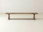 The Heirloom Bench - Harvest Wheat on Alder by James+James features turned legs and a rustic finish, displayed against a plain, light-colored background.
