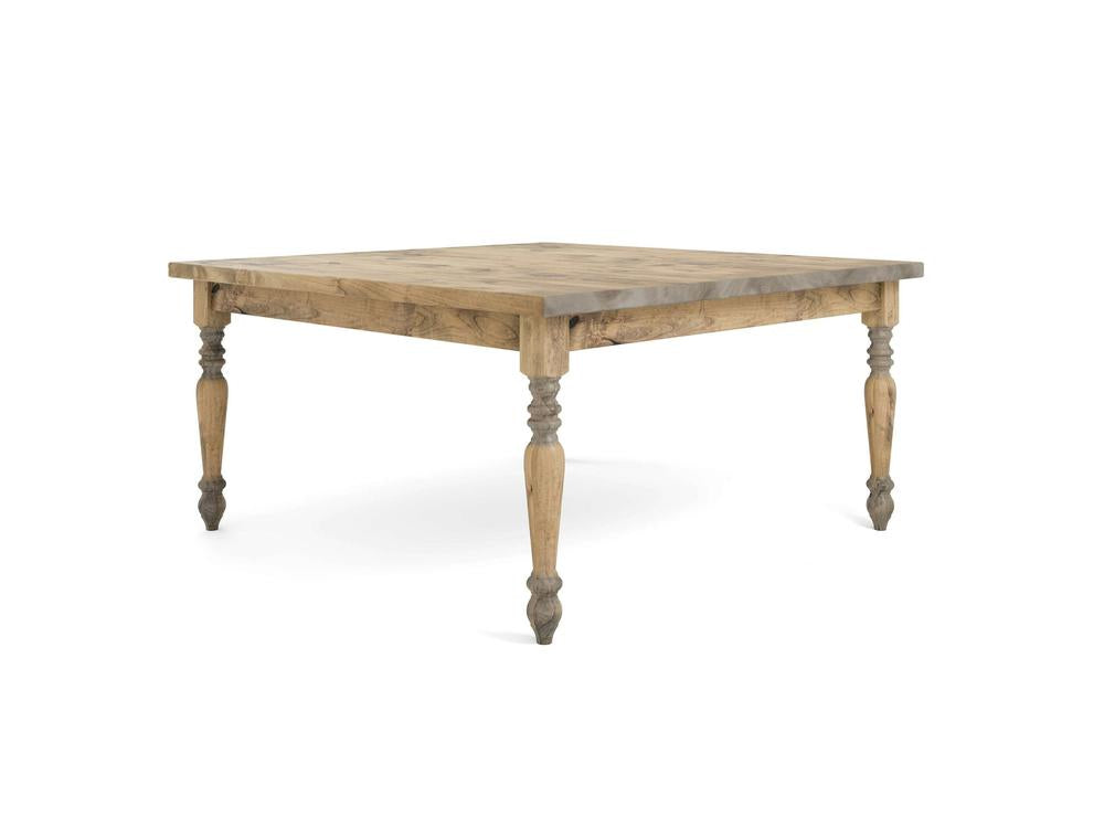 The French Country Square Dining Table - Harvest Wheat by James+James features a wooden square top with four intricately carved legs. It boasts a natural, rustic finish that highlights the wood grain and showcases exceptional craftsmanship. The tapered legs are adorned with decorative, turned details at both the top and bottom.