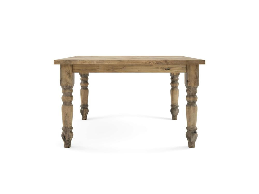 The Baluster Square Dining Table in Harvest Wheat by James+James features a rectangular top and four intricately carved legs. The visible natural wood grain gives the table a vintage and handcrafted appearance, all set against a white background.