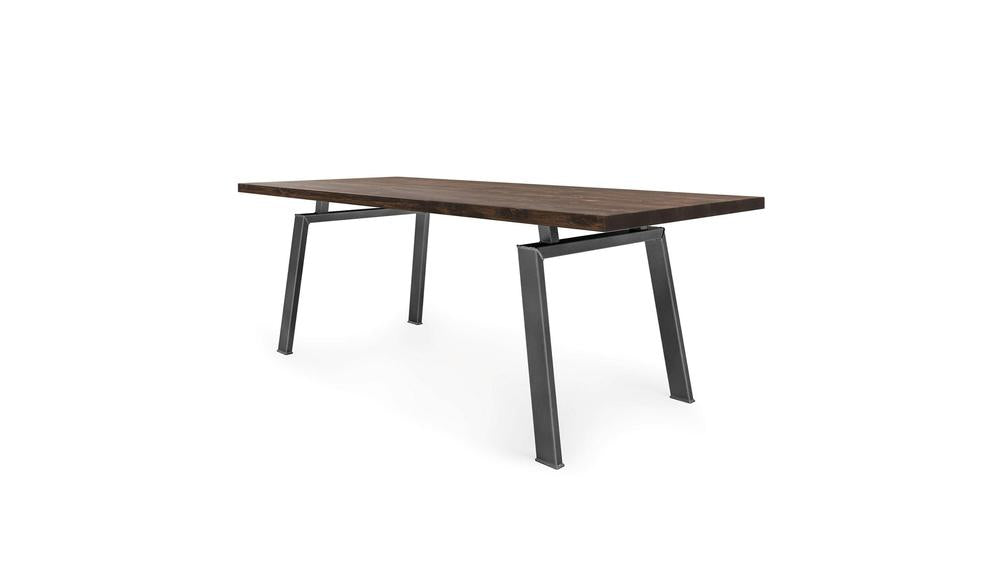 The Fulton Dining Table - Tobacco by James+James features a modern rectangular design with a dark wooden top and angled, sturdy metal legs. Its minimalist and sleek design seamlessly blends contemporary and industrial styles, with unique angular metal legs adding both stability and visual interest.
