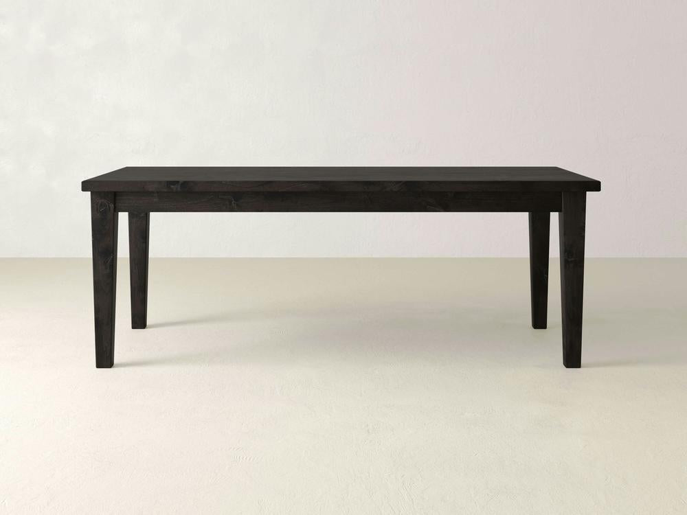 Product Description:
The Ava Parsons Dining Table - Charred Ember from James+James features a minimalistic design with clean lines and a smooth surface. This simple, rectangular black wooden dining table is fitted with four straight legs and is set against a plain, light grey background.