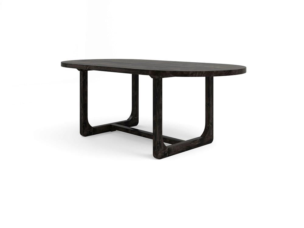 The Emersen Oval Dining Table - Charred Ember by James+James is showcased against a white background. This minimalist dark wooden table features an oval top with curved edges and a unique angular base that exudes a modern aesthetic.