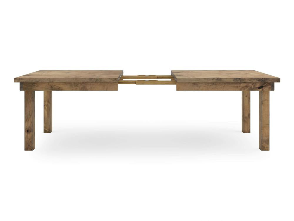 Introducing the Farmhouse Expandable Dining Table - Harvest Wheat by James+James. This rustic wooden dining table is displayed in its extended form, revealing a visible expansion mechanism at the center. It features straight, simple legs and a rectangular shape against a plain white background.