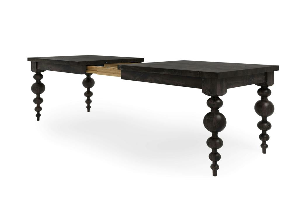 The Olivia Expandable Dining Table from James+James, in the Charred Ember finish, features a dark wooden surface with turned spindle legs. Displayed with its extension mechanism partially engaged, this rectangular table showcases a classic design.