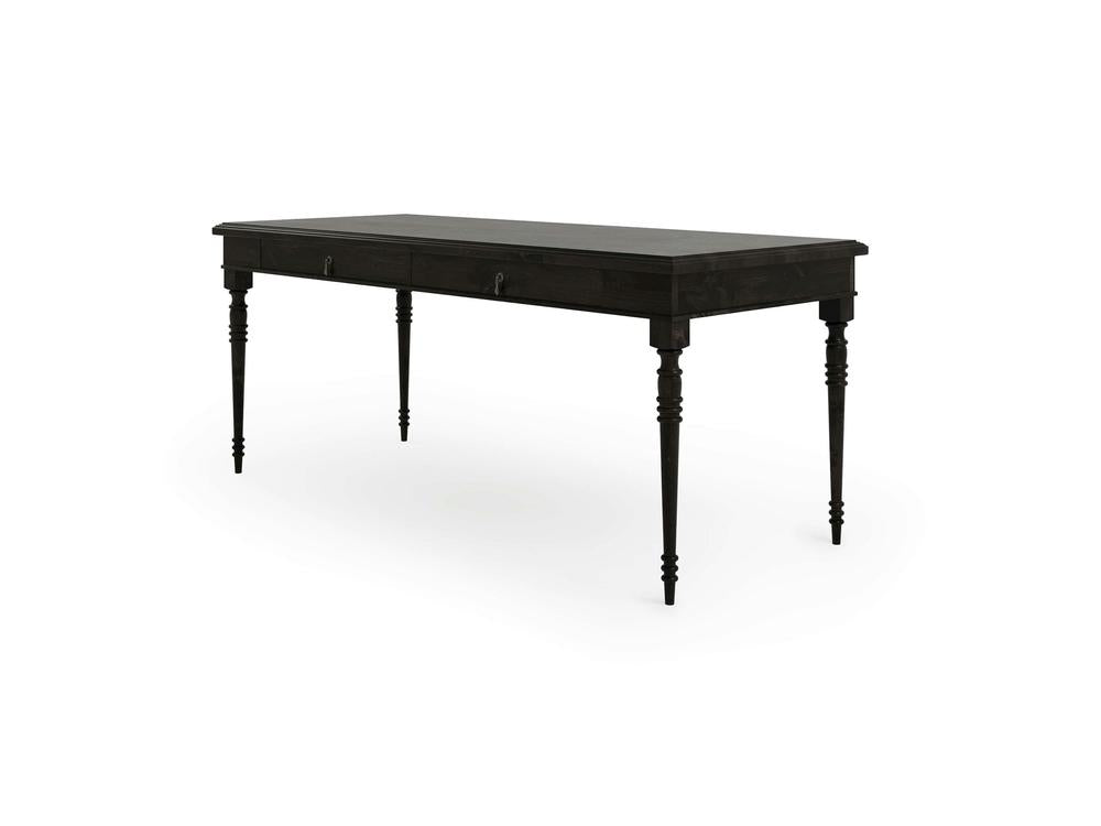 The Audrey Desk - Charred Ember by James+James is a rectangular, dark wood desk featuring two small drawers underneath the tabletop. It stands on four slender, turned legs that showcase intricate detailing. The desk has a classic design and is shown against a plain white background.