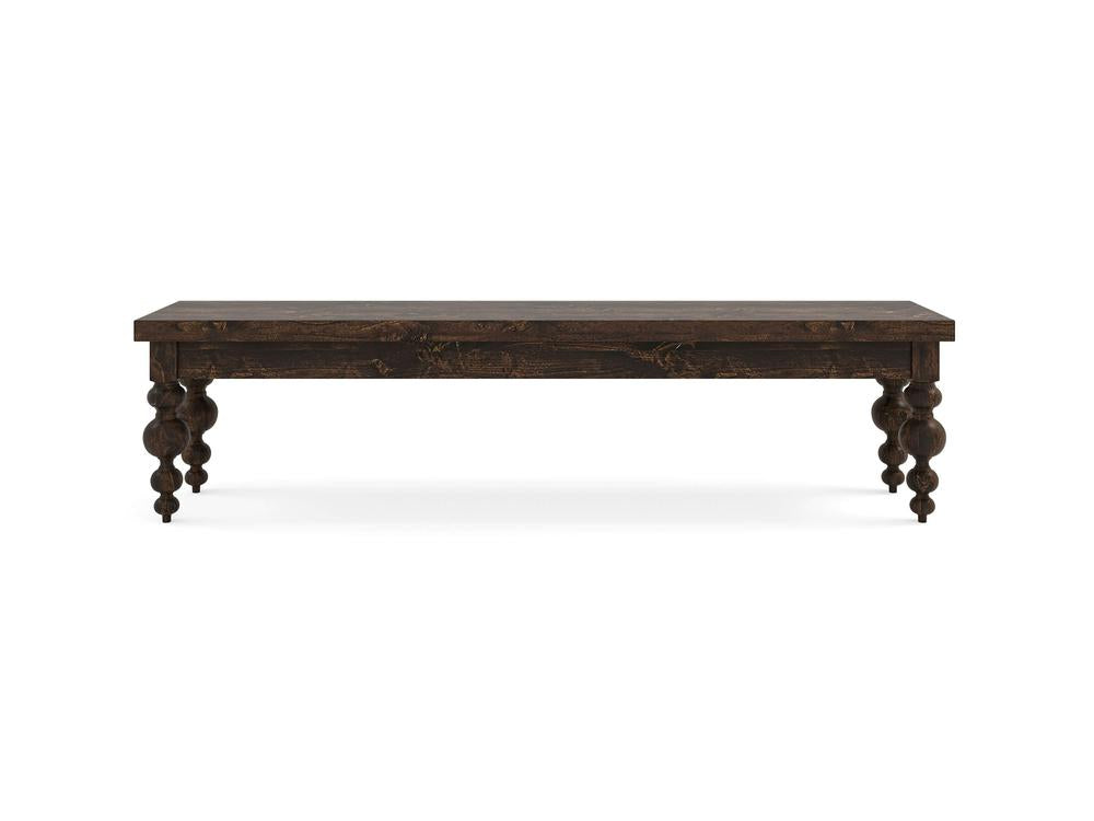 The Olivia Bench - Tobacco on Alder by James+James features a rectangular wooden design with a dark finish and four intricately turned legs, displayed against a white background.