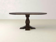 The Heirloom Oval Dining Table by James+James, showcasing an exquisite pedestal design with four supporting feet, features a rich dark finish and a smooth, glossy surface. Set against a plain white background, this wooden masterpiece exudes elegant craftsmanship.