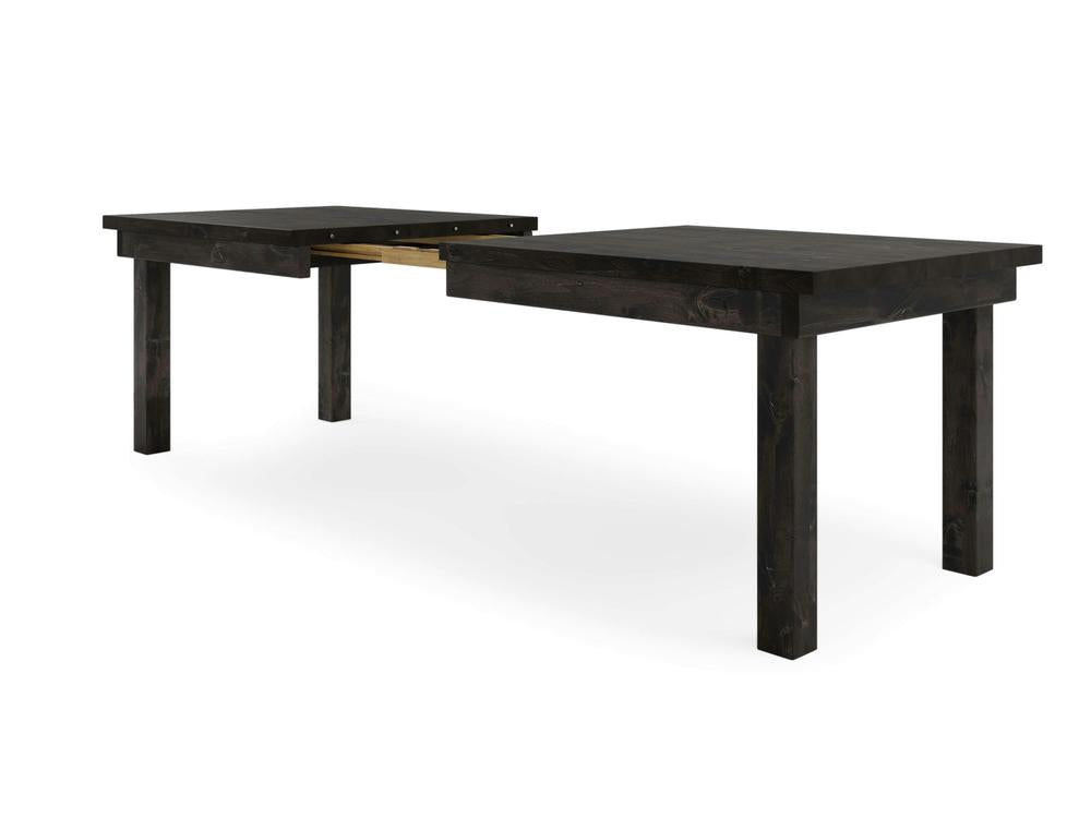 The Farmhouse Expandable Dining Table - Charred Ember by James+James features a dark wooden, rectangular top and four sturdy legs. A visible seam down the middle highlights its extendable design, ideal for accommodating more people or items. The background is plain white.