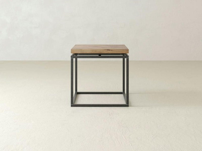 The Floating Top End Table by James+James is a minimalist side table showcasing a hardwood top and a sleek black metal square frame base. Ideal for modern decor, this end table is set against a plain, light-colored background.