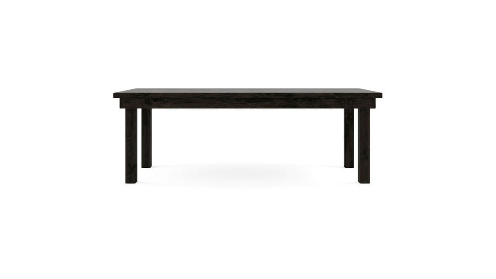 The James+James Farmhouse Dining Table in Charred Ember features a minimalist, dark wooden construction with a rectangular top and four straight legs, set against a white background. Its simple and functional design makes it ideal for dining or serving as a workspace.