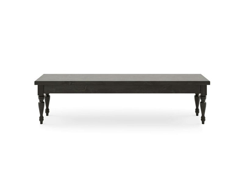 The Chateau Bench - Charred Ember by James & James is a long, rectangular black table with a smooth top and four intricately carved legs, set against a plain white background.