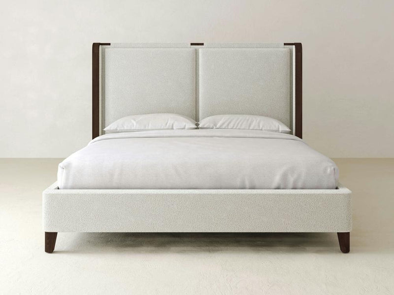 Experience modern elegance with the James & James Holden Bed – Boucle, a minimalistic masterpiece featuring a high headboard and neutral-toned pillows. This contemporary design is enhanced by solid maple wood accents against a plain background.