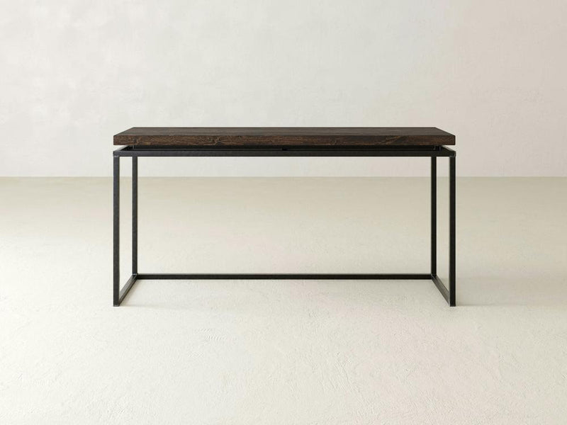 Introducing the Floating Top Sofa Table - Tobacco by James+James: a minimalist wooden table featuring a dark wood top and a black metal frame. This table boasts a rectangular surface and straight, simple legs, elegantly set against a plain, light-colored background.