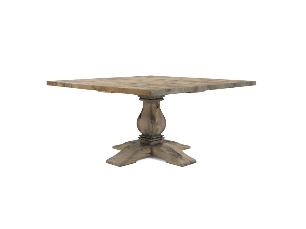 The Heirloom Square Dining Table - Harvest Wheat by James+James features a rustic design with a thick tabletop and a sturdy, ornate pedestal base. Made of distressed wood, it offers a weathered, vintage look.