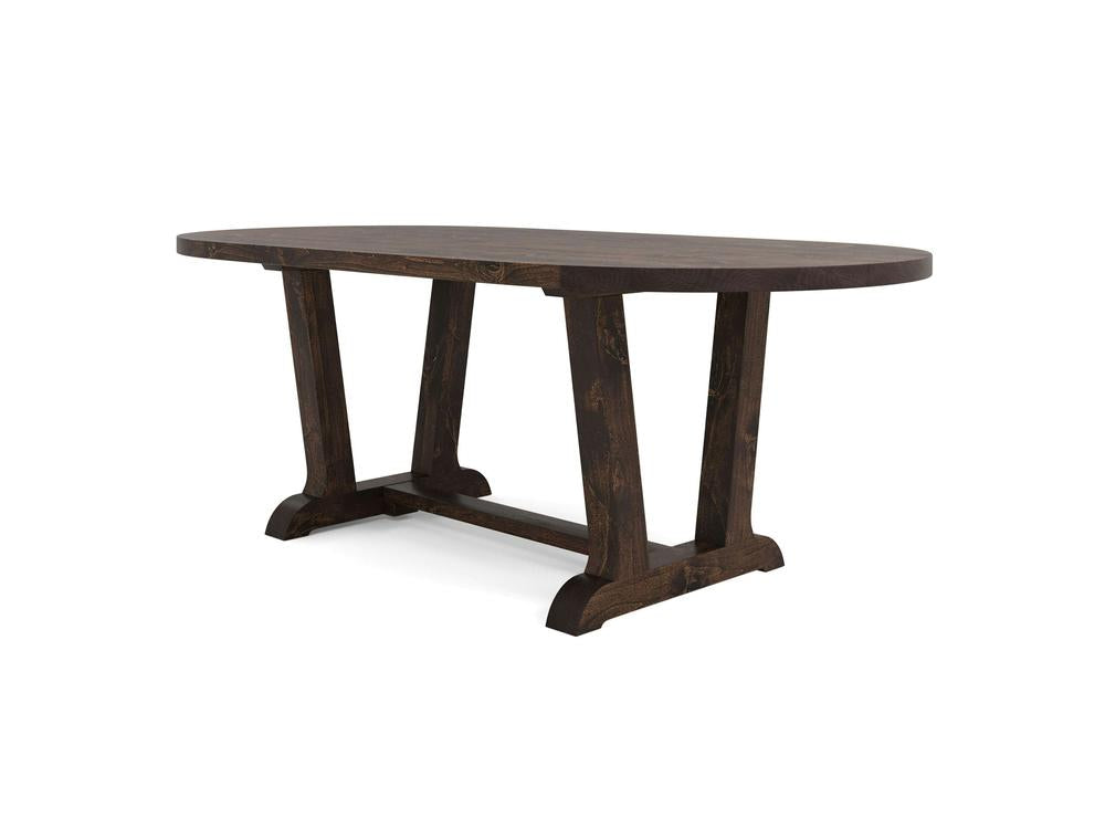 The Thaden Oval Dining Table in Tobacco by James+James features a dark wooden finish, an oval-shaped top, and sturdy rectangular legs connected by a horizontal support beam. Its simple yet elegant design highlights the natural wood grain and offers ample seating space.