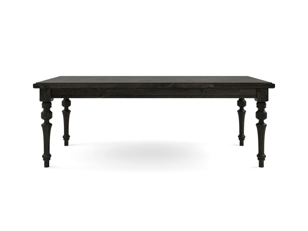 The Allyson Dining Table - Charred Ember by James+James features a dark wooden rectangular top and intricately designed turned legs, showcased against a plain white background. This table exudes a classic, antique style with a sturdy and elegant appearance.