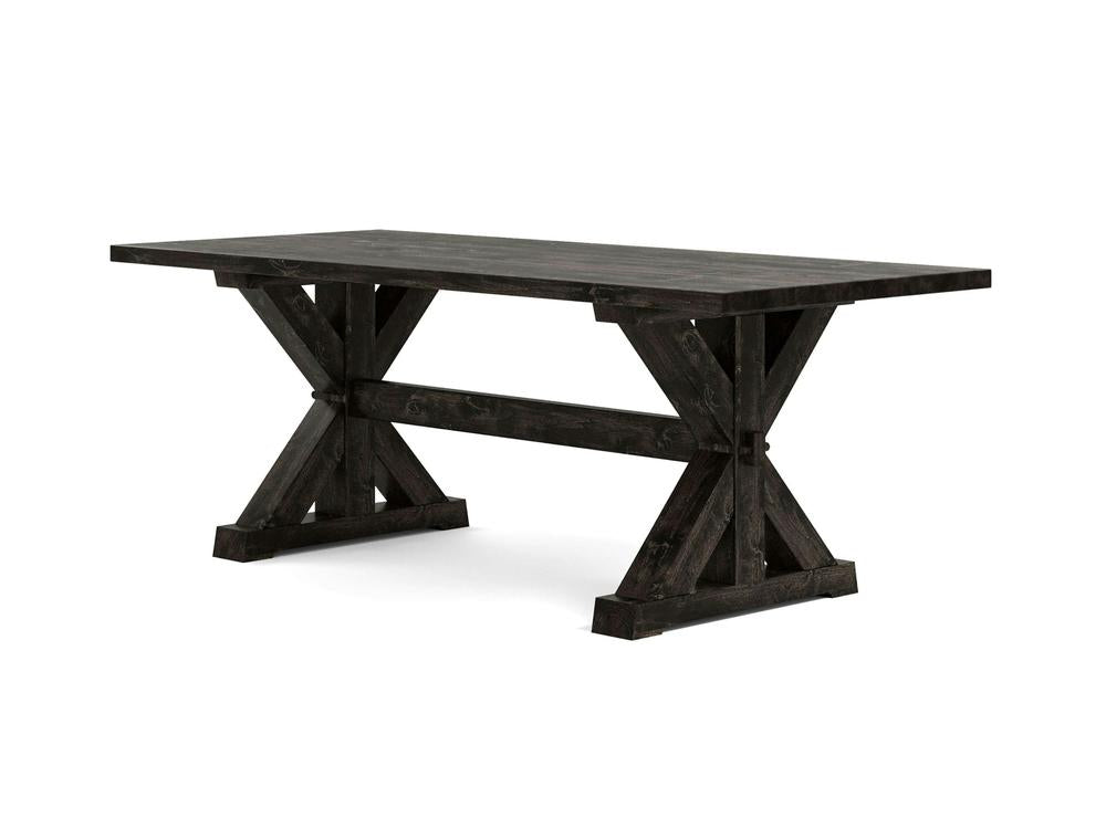 The Trestle Dining Table - Charred Ember by James+James features a dark wooden rectangular top with two X-shaped trestle supports at each end, connected by a horizontal stretcher for added stability. This rustic, farmhouse-style table is depicted against a plain white background.