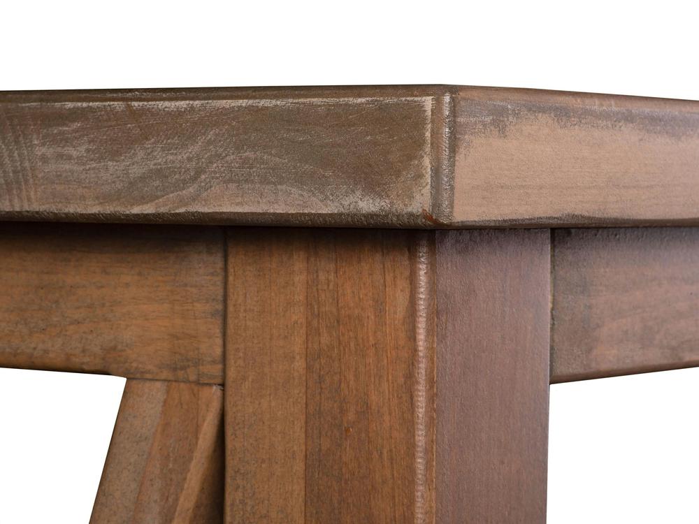 Close-up view of the Carter X Coffee Table - Harvest Wheat by James+James, showcasing a smooth finish with visible wood grain and intersecting legs. The table appears sturdy and well-crafted with a light to medium brown stain.