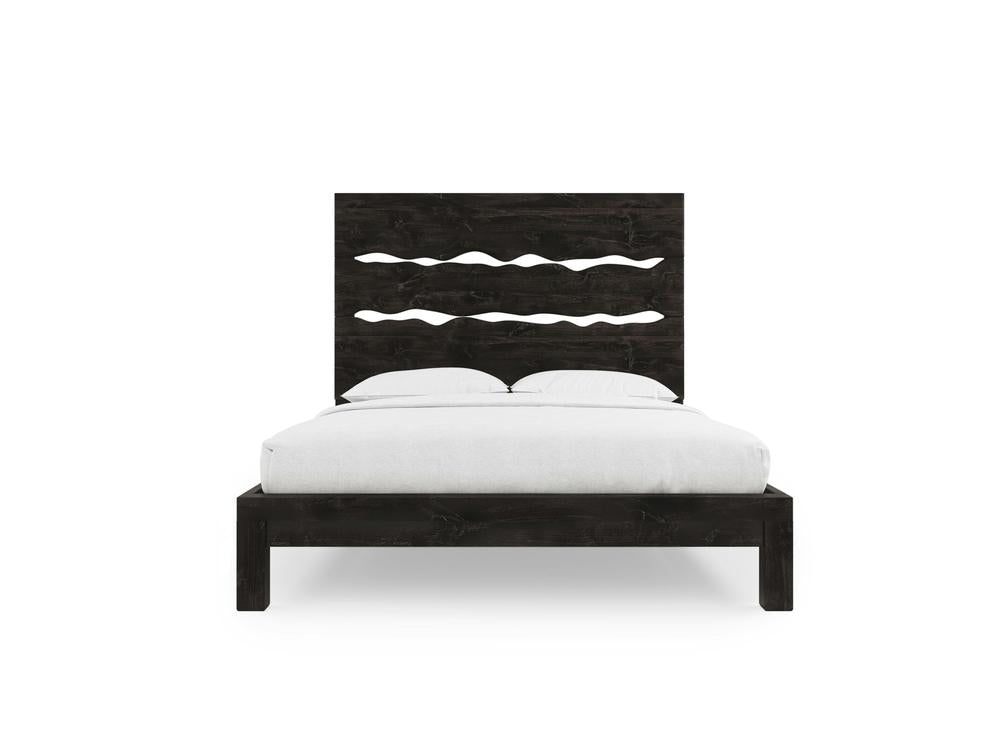 The James+James Live Edge Bed - Charred Ember on Alder features a dark wooden frame and tall headboard with three wavy cut-outs, shown styled with white bedding and pillows.