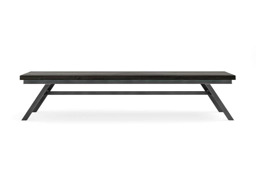 The Fulton Bench - Charred Ember on Alder by James+James features a modern rectangular design with clean lines, a flat top, angled legs, and a sturdy minimalist look, shown here against a plain white background.