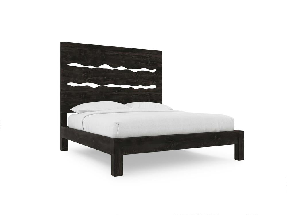 The James+James Live Edge Bed - Charred Ember on Alder features a dark wooden frame with a tall headboard adorned with three wavy cut-out designs, shown here paired with crisp white bedding against a simple white background.