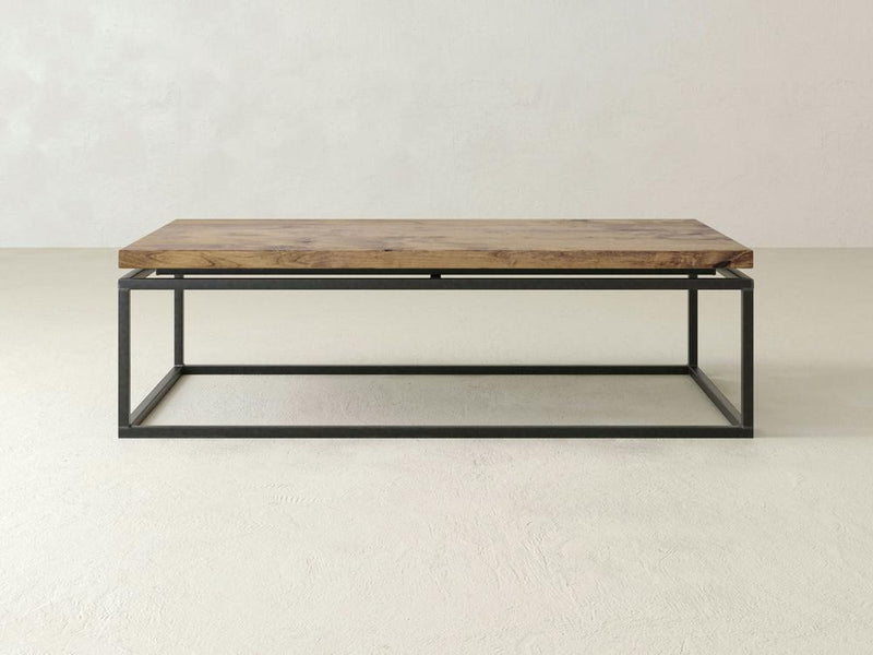 A close-up of the Floating Top Coffee Table - Harvest Wheat by James+James showcases a smooth grain and a natural knot on the right side. The wood exhibits shades of light to medium brown, featuring subtle variations and a slightly weathered appearance.