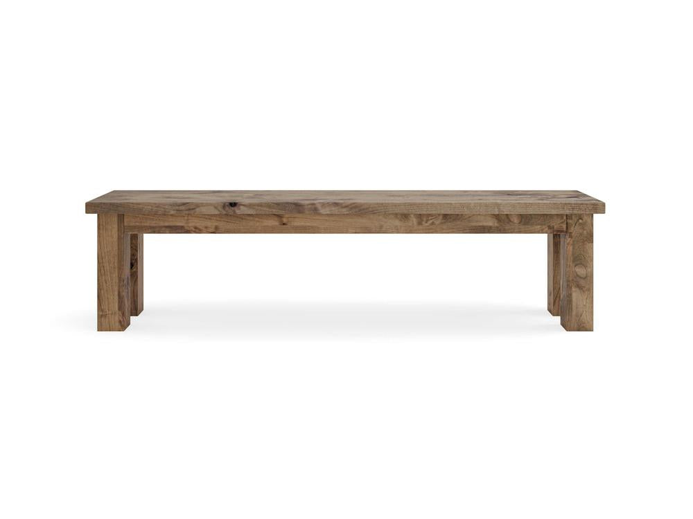 The Farmhouse Bench - Harvest Wheat on Alder by James+James features a natural wood finish, rectangular seat, four sturdy legs, and a minimalist rustic design. It's shown against a plain white background.