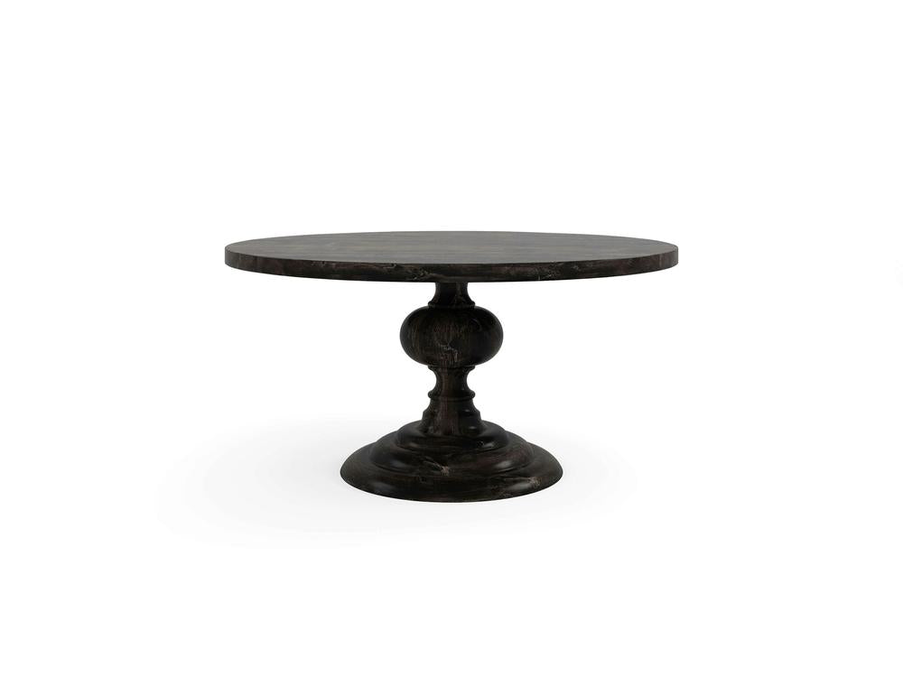 The Josephine Round Dining Table - Charred Ember by James+James is a dark wood round table featuring a single ornate pedestal base. The table top is smooth and polished, while the base showcases intricate carvings and a sturdy design. The overall look is elegant and classic.