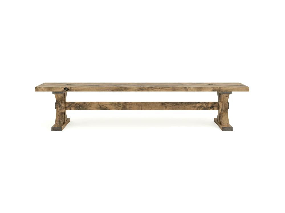 The James+James Trestle Bench in Harvest Wheat on Alder features a flat rectangular seat, sturdy legs, and a horizontal support beam in a natural wood finish, photographed against a white background.
