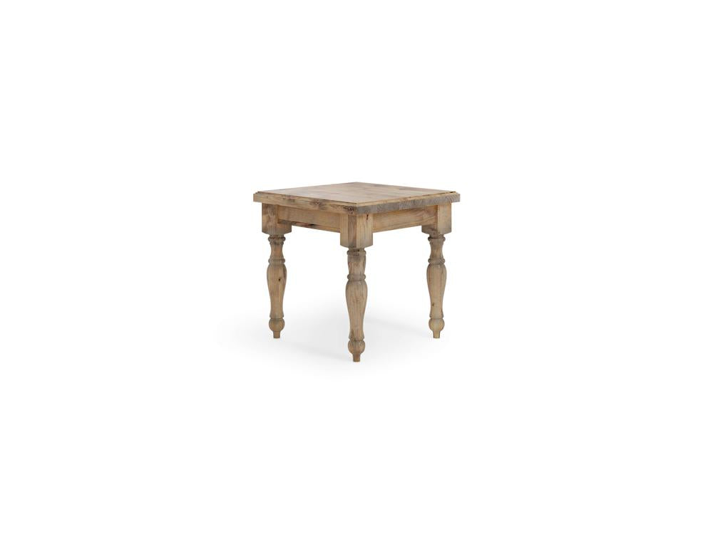 The Abigail End Table by James+James features a small, rustic wooden design with a square top and four turned legs. It has a natural harvest wheat finish and appears handcrafted, providing a vintage or farmhouse aesthetic. Its overall design is simple yet sturdy.