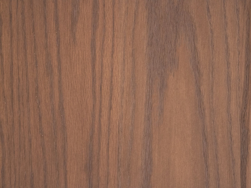 Close-up of the James+James Almond on Oak Sample shows a warm brown oak surface with vertical natural grain patterns.