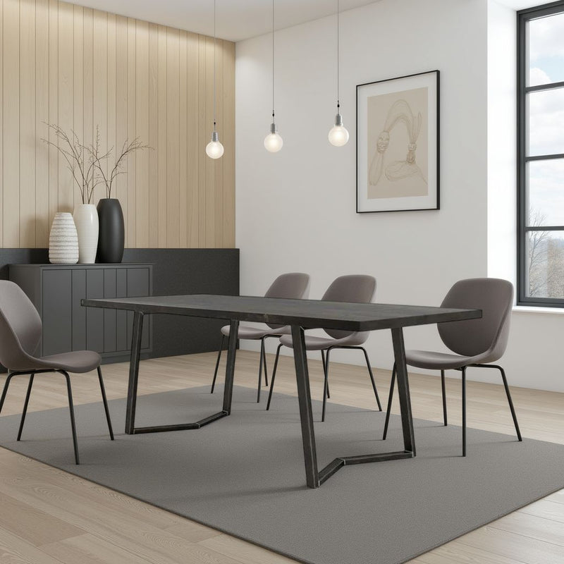 A modern dining room featuring the James+James Arkwright Dining Table in Charred Ember, four gray chairs, a gray rug, light wood floors, a black sideboard with vases, pendant lights, wall art, and large windows with natural light.