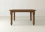 The Fulton Corner Desk - Tuscany by James & James features a smooth rectangular top and four turned legs, shown on a light floor against a plain white background.