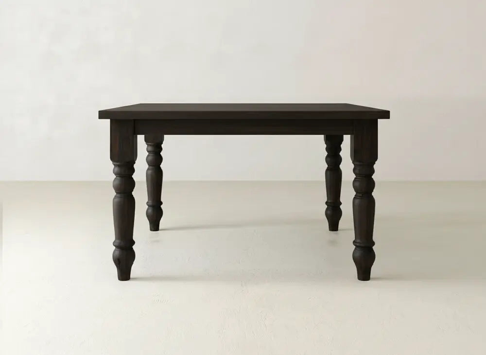 The Fulton Corner Desk - Tuscany by James & James features a dark wood finish, a rectangular top, and four intricately carved legs, displayed against a plain light-colored background.