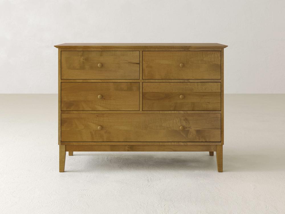 The Bennett 5 Drawer Dresser by James & James features a sleek, minimalistic design crafted from solid maple wood. It includes two smaller top drawers, with one longer drawer in both the middle and bottom rows, all finished with a smooth natural wood look for timeless appeal.