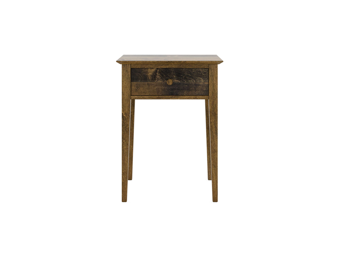 A wooden side table with a single drawer and four slender legs, featuring a rustic finish. The drawer has a round knob in the center. The table is isolated on a white background.