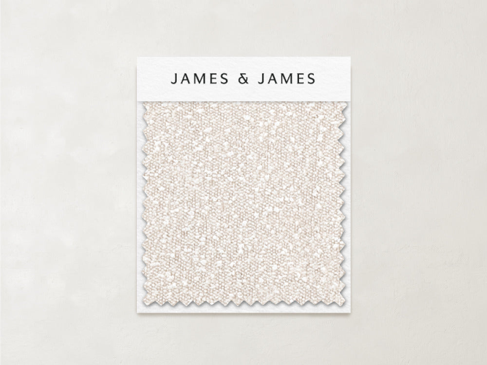 A Bisque - Boucle Swatch featuring off-white, gently textured bouclé fabric with a zigzag edge is displayed on a card labeled "James+James" against a light background.