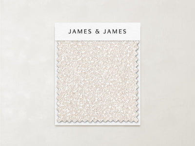 A Bisque - Boucle Swatch featuring off-white, gently textured bouclé fabric with a zigzag edge is displayed on a card labeled "James+James" against a light background.