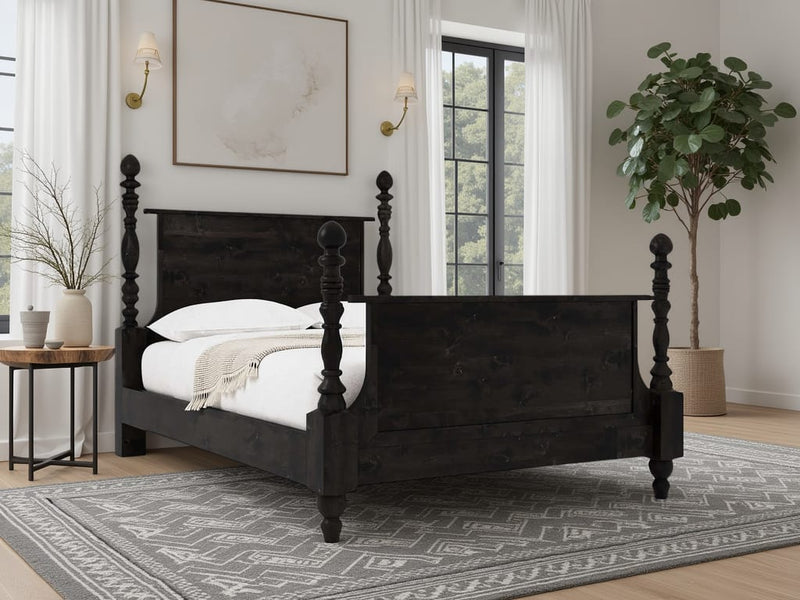 A bedroom featuring the James+James Catherine Bed in Charred Ember, white bedding and throw, gray patterned rug, large window with white curtains, potted plant, round side table, and wall art above the bed.