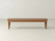 The Chateau Bench - Oat on Alder by James & James features a rectangular wooden seat and four turned legs, shown against a plain white wall and light-colored floor.