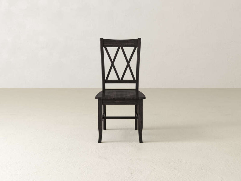 The Double X-Back Dining Chair - Tobacco by James+James is displayed from a rear angle. The backrest showcases an elegant double X-pattern design, while the chair possesses a straightforward construction with slightly curved legs and a flat, smooth seat in a rich dark finish.